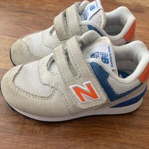 New Balance 574 Toddler Hook and Loop White & Blue Sneakers with Orange Accents